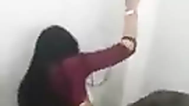 A beautiful Muslim girl indulges in sexual activity with a teen man in a restroom stall